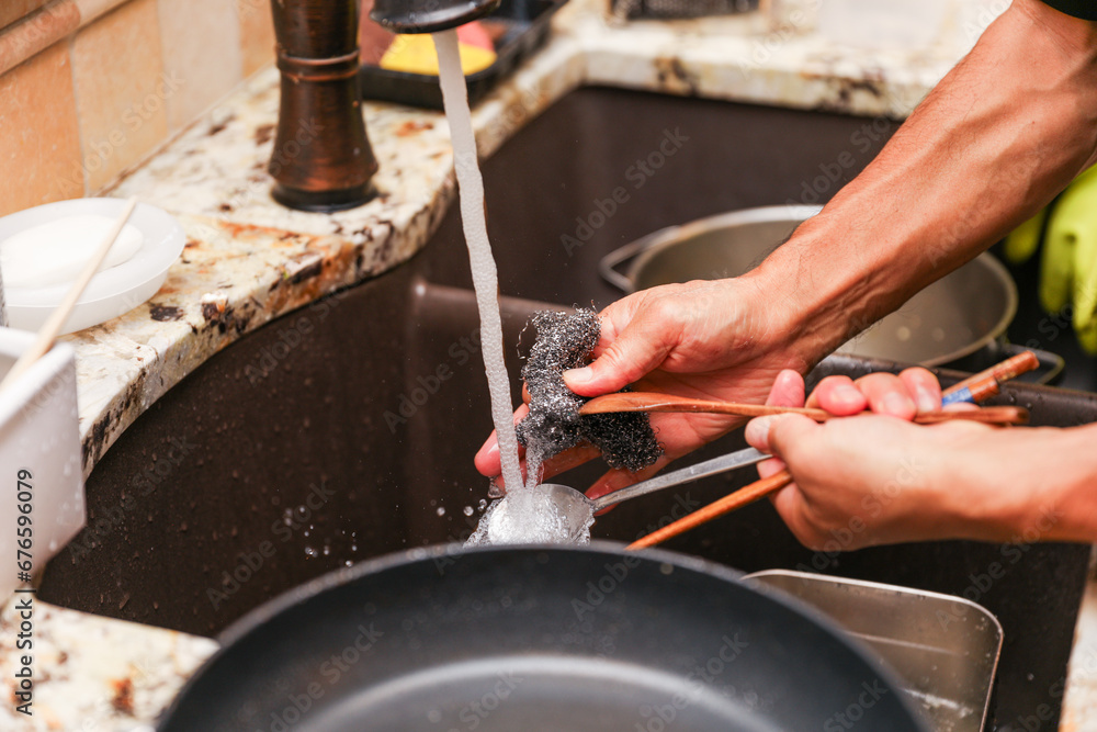 handwashing dishes, symbolizing equality and shared responsibilities