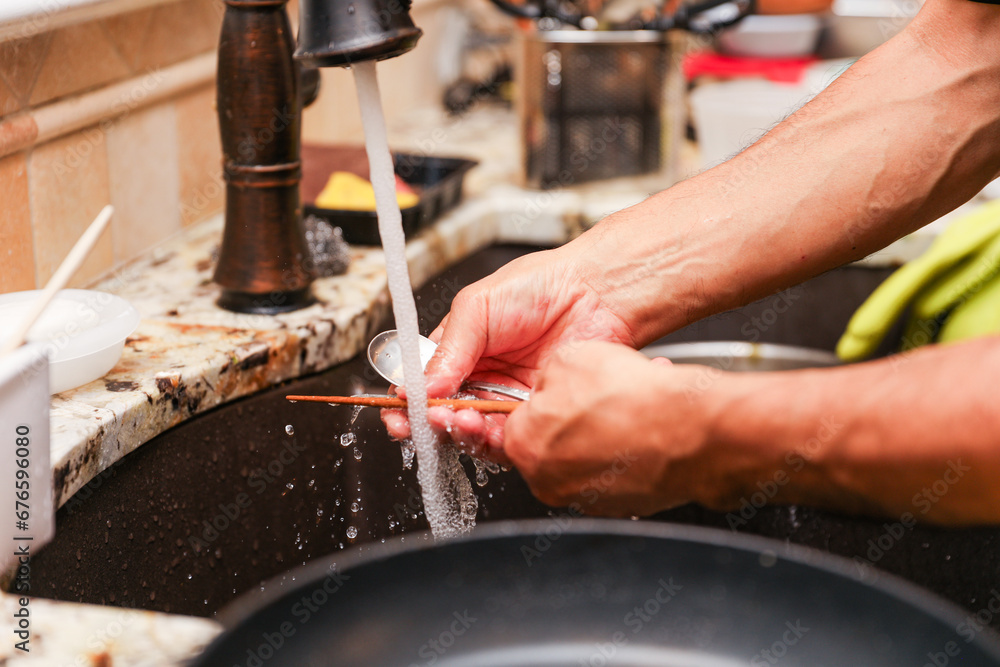 handwashing dishes, symbolizing equality and shared responsibilities
