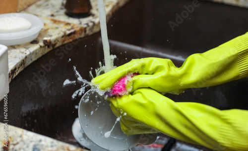 hand-washing dishes, symbolizing equality and shared responsibilities of men and women gender roles responsibilities. Hand washing vs dishwasher technological advances 
