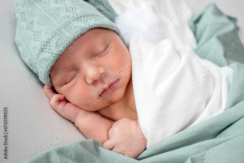 Close up of cute newborn baby sleeping on white background covered.Care,love,happiness concept.
