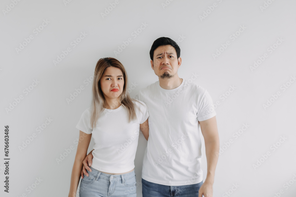 Advertisement copy space of boring face asian lover couple isolated on white. Advertisement copy space of boring face asian lover couple isolated on white.