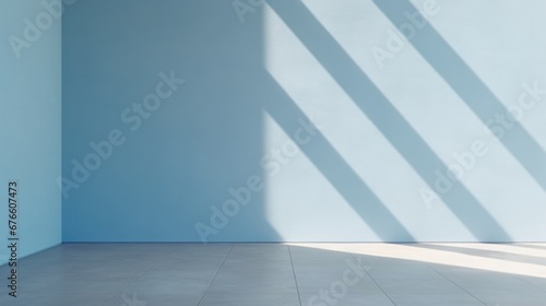 Abstract light blue background, perfect for product presentations. Shadows and light from the window on the cement wall Morning light enters through the diagonal window.