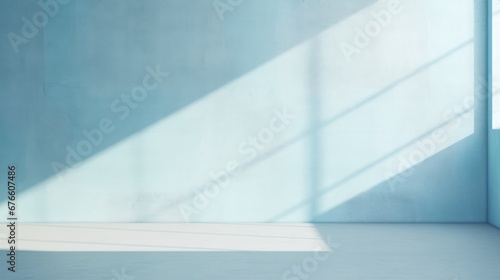Abstract light blue background  perfect for product presentations. Shadows and light from the window on the cement wall Morning light enters through the diagonal window.