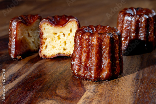 Canele, French pastry flavored with rum and vanilla, soft and tender custard center and  dark, caramelized crust specialty of Bordeaux region, France photo
