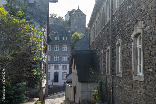 Fototapeta Naklejka Na Ścianę i Meble -  View of houses and streets of old colourful German town Monschau in bend of the river and hidden between the hills, Eifel national park, Germany