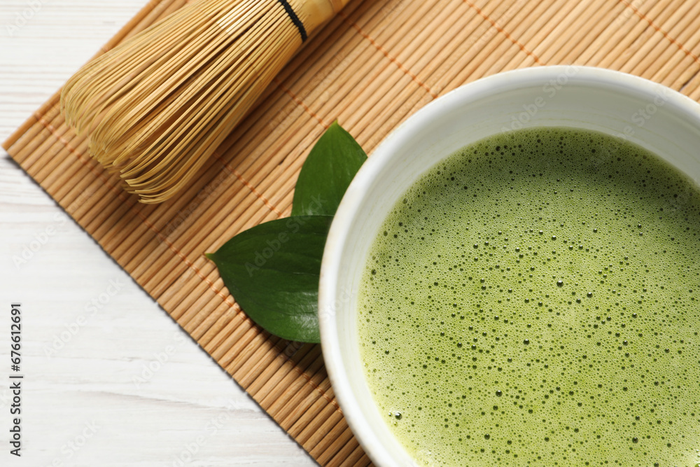 Cup of fresh matcha tea and bamboo whisk on table, top view Cup of fresh matcha tea and bamboo whisk on table, top view