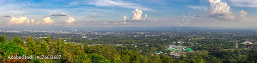 Panorama view of Chiangmai Chiang Mai city taken from Doi Suthep Mountains. Lovely views of the Old city at Sunset Sunrise lovely tropical mountains and beautiful nature in the foreground photo