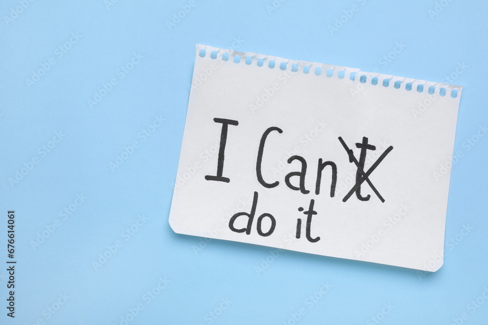 Motivation concept. Changing phrase from I Can't Do It into I Can Do It by crossing out letter T on light blue background, top view. Space for text Motivation concept. Changing phrase from I Can't Do It into I Can Do It by crossing out letter T on light blue background, top view. Space for text