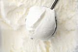 Steel scoop with tasty vanilla ice cream, top view