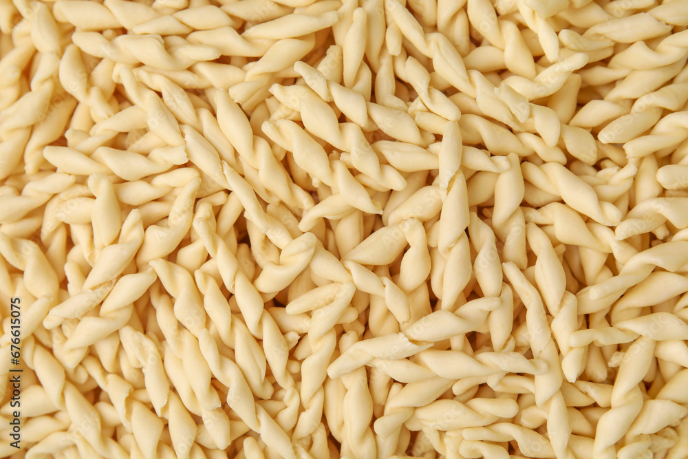 Uncooked trofie pasta as background, top view Uncooked trofie pasta as background, top view