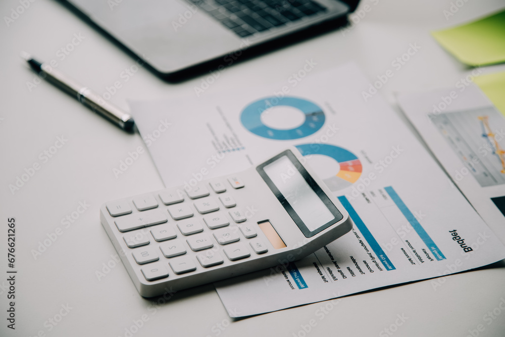 Businesswoman or accountant working Financial investment on calculator, calculate, analyze business and marketing growth on financial document data graph, Accounting, Economic, commercial concept. Businesswoman or accountant working Financial investment on calculator, calculate, analyze business and marketing growth on financial document data graph, Accounting, Economic, commercial concept.