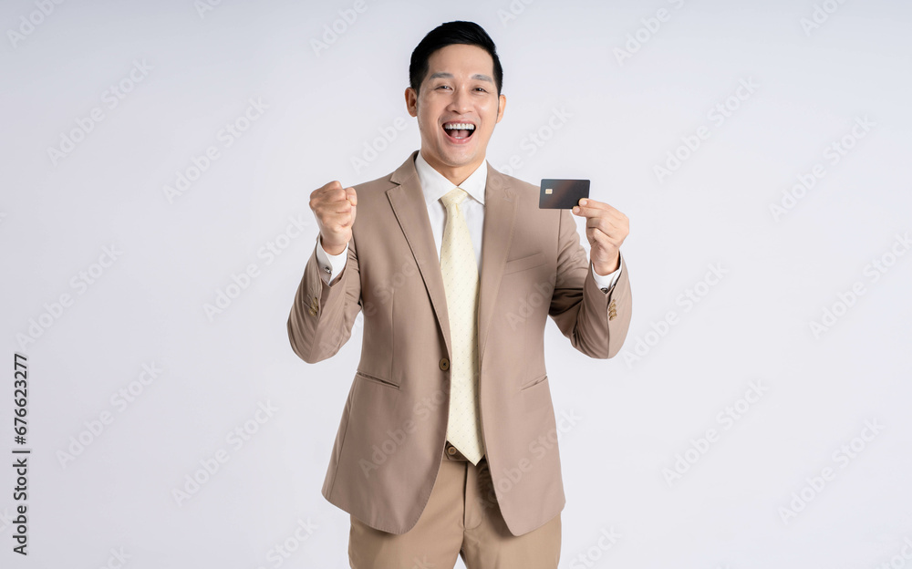Image of Asian male businessman holding card credit on white background Image of Asian male businessman holding card credit on white background