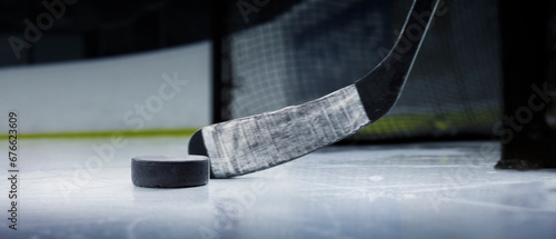 Hockey puck and stick close-up. Focus on the puck. The stick in action. Hockey concept. Ice