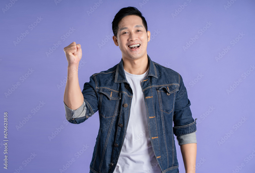 Image of Asian man posing on purple background Image of Asian man posing on purple background