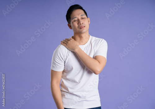 Image of Asian man posing on purple background