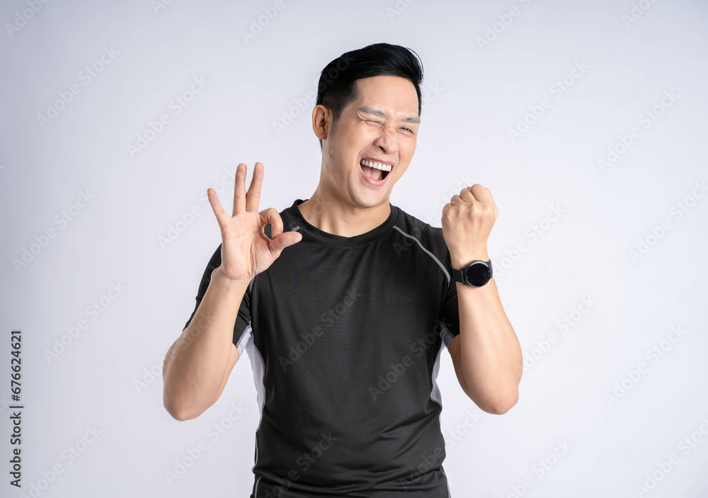 Fototapeta premium Portrait of a man wearing sports clothes posing on a white background
