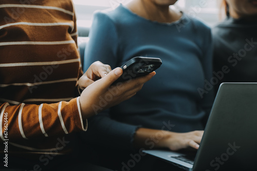 Beautiful woman sitting on a outdoors and using at laptop. Woman and friend having fun with new technology and shopping online at outdoor place. photo