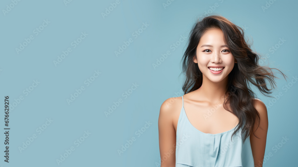 Asian woman model wear a blue sundress isolated on pastel background Asian woman model wear a blue sundress isolated on pastel background