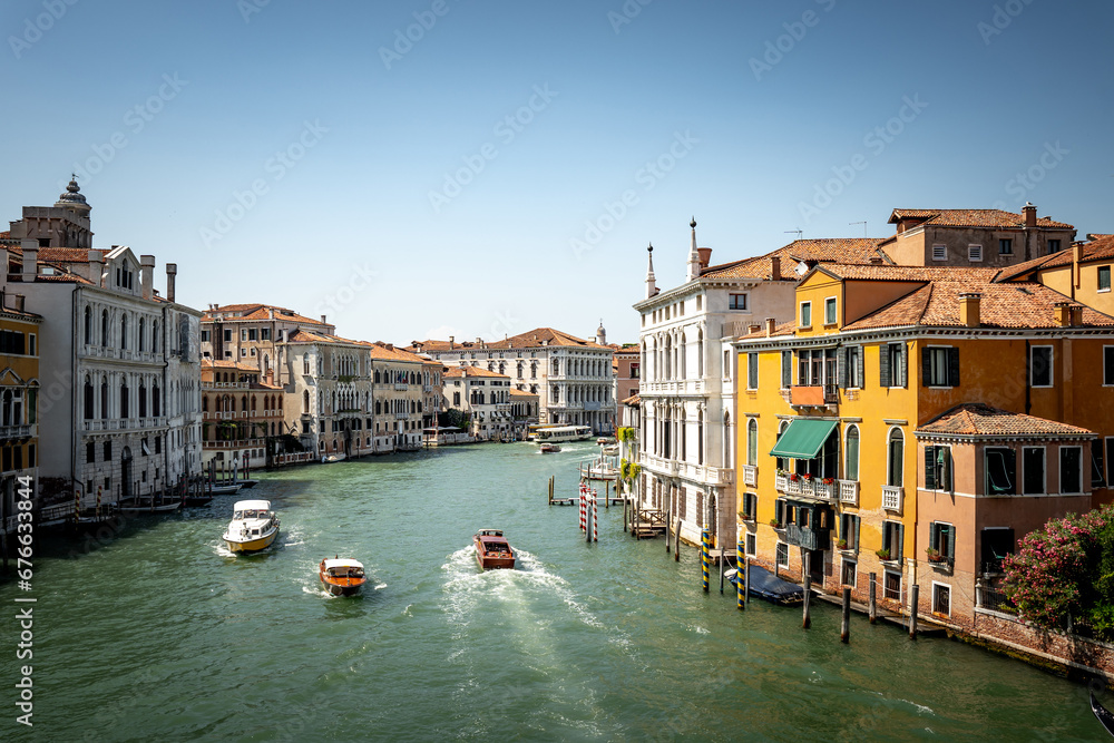 Obraz premium Scenic canal with old buildings in Venice, Italy. Boats as the mean of the transportation