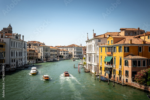 Scenic canal with old buildings in Venice, Italy. Boats as the mean of the transportation