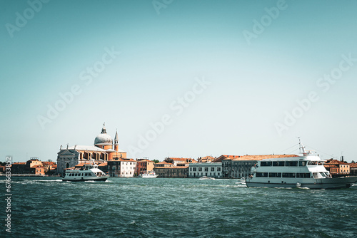 Scenic canal with old buildings in Venice, Italy. Boats as the mean of the transportation