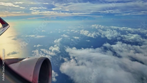 .from the airplane window Propeller and wings next to the window..an airplane flying past fluffy white clouds..The slope of the horizon shifts with the plane.The atmosphere in the sky is beautiful.