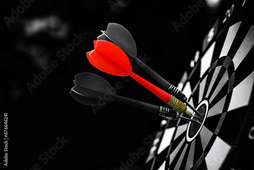Bullseye or Bulls eye target or dartboard has red dart arrow throw hitting the center of a shooting for financial business targeting planning and aim to winner goal of business concept.