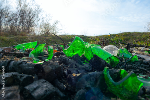 Broken glass bottles, garbage in nature
