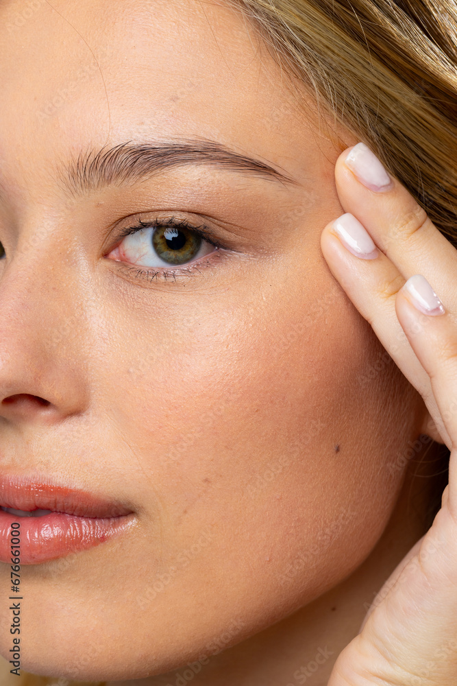 Portrait of caucasian woman wearing natural makeup and beige nail polish