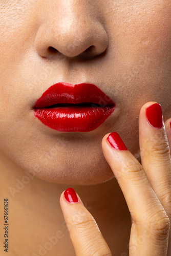 Close up of asian woman wearing red lipstick and nail polish