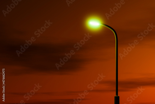 Street lighting poles against the sky in the colors of sunset.