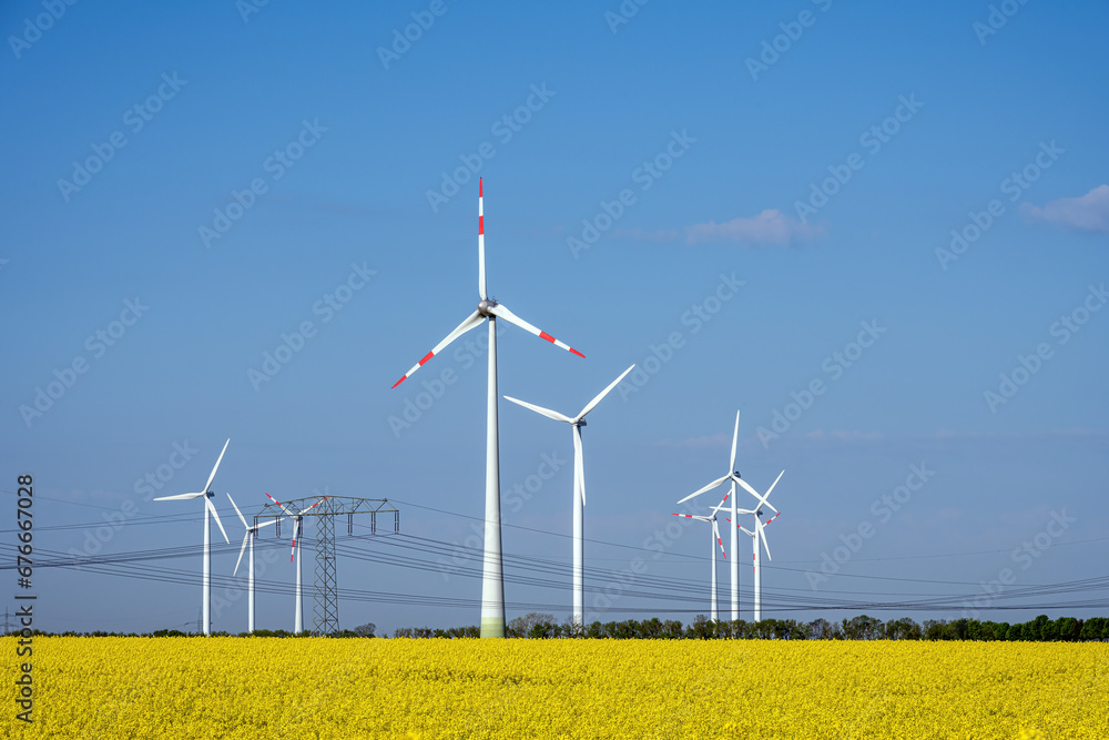 Wind turbines in a field of flowering rape seed seen in Germany Wind turbines in a field of flowering rape seed seen in Germany