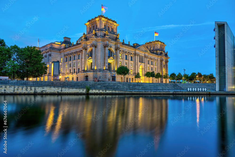 The imposing Reichstag, the german parliament building, at the river Spree in Berlin at dawn