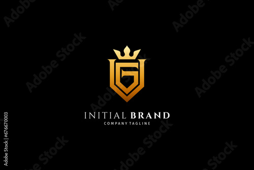 initial GV monogram letter logo luxury shield design with gold crown combination photo