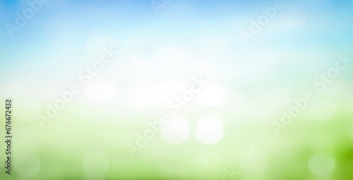 world environment day concept, Beautiful spring blur green nature with bokeh sun light flare and blue sky white cloud abstract background.