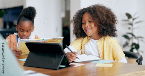 Kids, e learning and tablet with writing, book and reading for education, development and study at desk. Children, touchscreen and notebook with smile, online course and home school in family house photo
