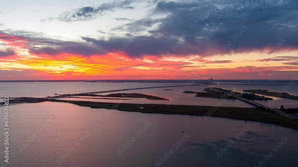 Fototapeta premium Mobile Bay causeway and the Jubilee Parkway bridge at sunset