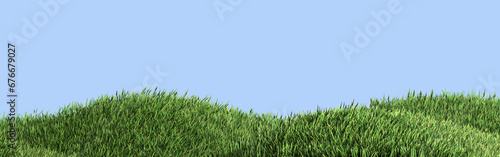 Horizontal panorama of green grass on the hills against the blue sky.