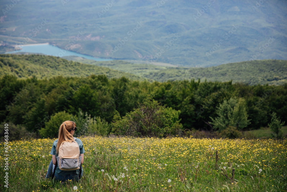 Woman on a hike looking at nature tourism Woman on a hike looking at nature tourism