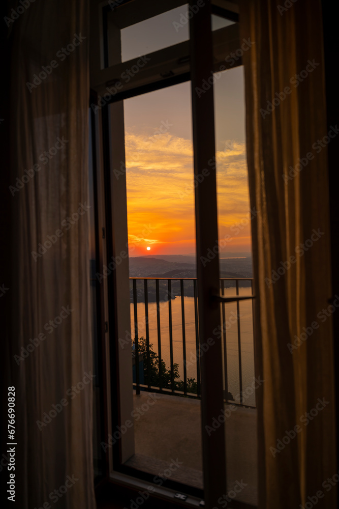 Window View with Balcony over Lake Lucerne with Mountain in Sunset in Burgenstock, Nidwalden, Switzerland.
