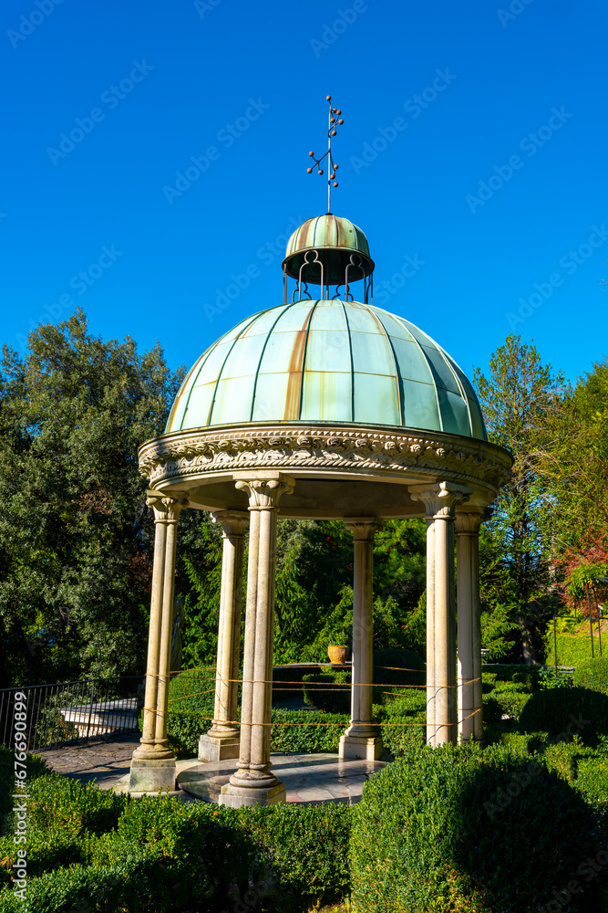 Dome with Column in the Forest on the Mountain Side and Blue Clear Sky in Park Scherrer in Morcote, Ticino, switzerland. Dome with Column in the Forest on the Mountain Side and Blue Clear Sky in Park Scherrer in Morcote, Ticino, switzerland.
