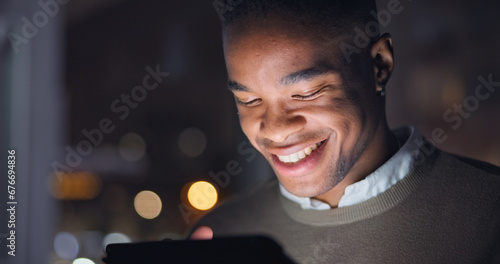 Businessman, night and reading with smile on digital tech, email with career progress in company. Black man, happy and touchscreen for online project growth, bokeh and feedback on startup expansion photo