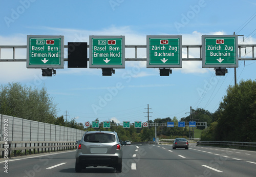 speed detector and payment of the motorway vignette with road signs with indications of many locations in Switzerland photo