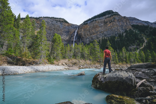 Takakkaw Falls, it tumbles down the cliff to more than 254 m high. Takakkaw is ranked among the highest waterfalls in Canada. These waters come straight from the Daly glacier to flow into the valley. photo