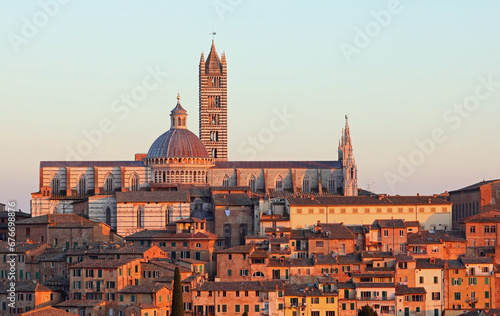Bell Tower and Cathedral of Siena in Tuscany at sunset photo