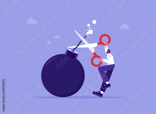 Business economic crisis concept, businessman holding scissors to cut the burning bomb fuse to relieve the crisis