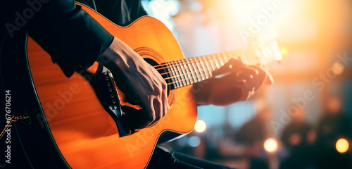 Musician play acoustic guitar on stage show performance, warm light dark halls. photo