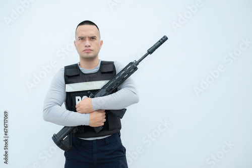 Portrait of police hold gun in hand on white background,Handsome asian cop