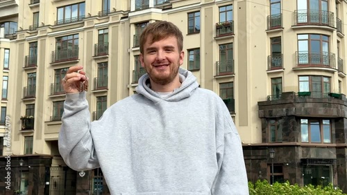 Young man with keys from a new house or apartment 