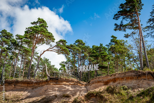 High coast of the sea in summer. Sand dunes with pine trees. Baltic sea coastline Jurkalne, Latvia. photo